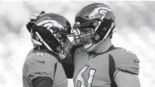  ?? RJ Sangosti, The Denver Post ?? Case Keenum, left, and Matt Paradis share a moment before the start of Saturday’s preseason game.