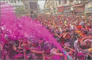  ?? (AP/Anupam Nath) ?? Indians dance during Holi festival celebratio­ns in Gauhati.