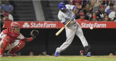  ??  ?? ANAHEIM: Kansas City Royals’ Lorenzo Cain hits a solo home run as Los Angeles Angels catcher Martin Maldonado watches during the eighth inning of a baseball game, Friday, in Anaheim, Calif. — AP