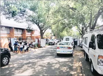  ??  ?? EVICTIONS: After a peaceful legal eviction in Windsor East, the Joburg High Court ordered that the tenants be reinstated. Tenants sit outside with their belongings.