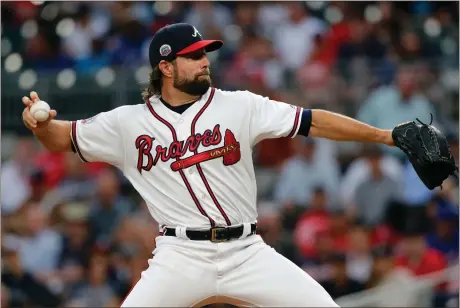  ?? John Bazemore / The Associated Press ?? Atlanta starting pitcher R.A. Dickey delivers during the first inning of Monday’s game against the San Francisco Giants SunTrust Park.