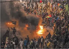  ?? FATIMA SHBAIR THE ASSOCIATED PRESS ?? Palestinia­ns in Gaza City celebrate after a shooting attack near a synagogue in East Jerusalem on Friday.
It was the deadliest attack on Israelis in years and raised the likelihood of further bloodshed.