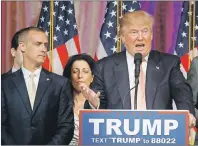  ?? AP PHOTO ?? Donald Trump's campaign manager Corey Lewandowsk­i (left) listens as Trump speaks in Palm Beach, Fla.