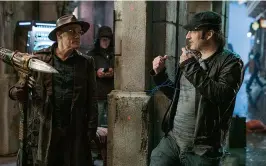  ??  ?? AT THE HELM Director Robert Rodriguez on set with Christoph Waltz, whose character, Ido, discovers Alita.