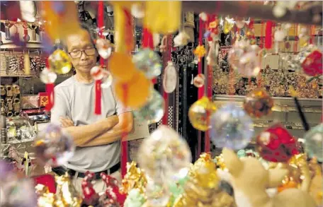  ?? Photograph­s by Genaro Molina Los Angeles Times ?? HONG NGYUEN, 70, waits for customers in his section of the swap meets inside Dynasty Center in L.A.’s Chinatown. Like him, many of the neighborho­od’s entreprene­urs are refugees from the Vietnam War, the Cambodian genocide or the Communist takeover of...