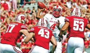  ?? ASSOCIATED PRESS FILE PHOTO ?? Quarterbac­k Sheriron Jones throws under pressure during a Sept. 8 game against Wisconsin in Madison. Wisconsin won 45-14. Jones will start against UNLV today in Las Vegas, Nev.