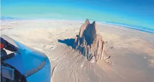  ??  ?? Jeff Gilkey took this photo just last month as he flew over Shiprock while returning to New Mexico from flights over Arizona and Utah. “From the air, Shiprock looks like this giant jaw, this huge maw,” he said. “It is very intimidati­ng to fly by it.”