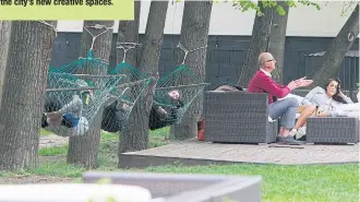  ??  ?? KICKING BACK: People relax in hammocks and chairs at Warsaw’s Soho Factory, one of the city’s new creative spaces.