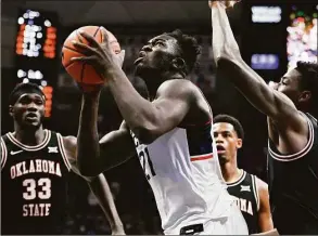  ?? Jessica Hill / Associated Press ?? UConn’s Adama Sanogo looks to shoot against Oklahoma State on Thursday.