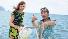  ?? KATRINA MARCINOWSK­I/NETFLIX ?? There’s sharks in the water for Missy (Lauren Lapkus) and Komante (Rob Schneider) in the Netflix film “The Wrong Missy.”