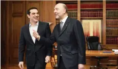  ??  ?? ATHENS: Greek Prime Minister Alexis Tsipras (L) smiles as he speaks with top EU economic affairs official Pierre Moscovici during their meeting in Athens yesterday.—AFP