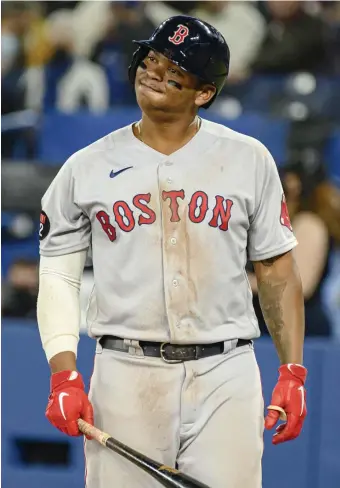  ?? Ap; BELOw, GETTy iMAGES ?? EMPTY PLATES: Rafael Devers gestures after taking a strike during the ninth inning against the Toronto Blue Jays on Thursday. Below, Kiké Hernandez taps himself on the head during his at-bat in the seventh inning.