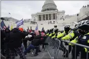  ?? JULIO CORTEZ — THE ASSOCIATED PRESS FILE ?? Trump supporters try to break through a police barrier at the Capitol in Washington.