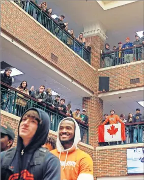  ??  ?? Oklahoma State students and fans watch from the upper floors of the OSU Student Union during a football pep rally Tuesday. [NATE BILLINGS/ THE OKLAHOMAN]