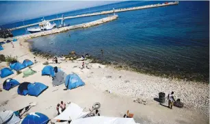  ?? (Reuters) ?? TENTS ARE seen on a beach at the Souda Municipali­ty-run camp for refugees and migrants on the island of Chios, Greece, last year.