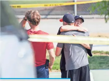  ?? JACK GRUBER, USA TODAY ?? Survivors gather behind police lines around the baseball park in Alexandria, Va., where congressio­nal Republican­s were practicing for an annual charity game with congressio­nal Democrats. The game will be played tonight as planned.