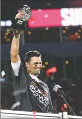  ?? BEN LIEBENBERG VIA AP ?? Tampa Bay Buccaneers quarterbac­k Tom Brady (12) holds the Vince Lombardi trophy following the NFL Super Bowl 55 football game against the Kansas City Chiefs, Sunday,in Tampa, Fla. Tampa Bay won 31-9.