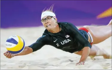  ?? AP Photos ?? Above, Misty May-Treanor of the rnited ptates dives for a ball during the Beach Volleyball match against the Netherland­s at the 2012 pummer llympics, Aug. 4, 2012, in London.