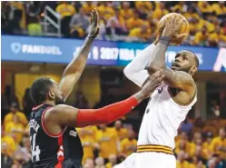  ?? THE ASSOCIATED PRESS ?? The Cleveland Cavaliers’ LeBron James, right, drives to the basket Monday against the Toronto Raptors’ Patrick Patterson in the first half in Game 1 of their second-round playoff series in Cleveland.