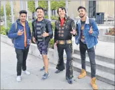  ?? SALLY COLE/THE GUARDIAN ?? Dressed in a tailor-made costume, Jonah Anderson talks to Holland College students while in Charlottet­own to promote his show this week. “An Evening with Elvis” is today, 7:30 p.m. at the Kings Playhouse in Georgetown. From left are Bajinger Singh, Bipin Thapa and Victor Kaoki.