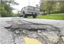  ?? STAFF PHOTO BY TIM BARBER ?? Inside the city of Chattanoog­a near Red Bank, broken pavement is located on the center double-yellow line in the 1100 block of Altamont Road.