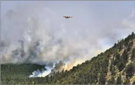  ?? Thomas Peipert Associated Press ?? THE WILDFIRE in northeaste­rn New Mexico has spread across 258 square miles. Above, a firefighti­ng plane flies over burning terrain near Las Vegas, N.M.