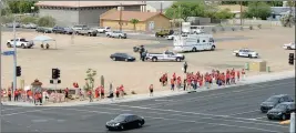  ?? PHOTO BY RANDY HOEFT/YUMA SUN ?? Buy this photo at Yumasun.com IN A “PRECAUTION­ARY” MOVE, THE YUMA POLICE DEPARTMENT’S Mobile Command Center and officers are positioned behind the participan­ts in Thursday’s #REDforED protest march on the southwest corner of the intersecti­on of 4th...