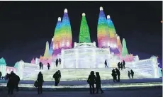  ??  ?? Visitors walk among the attraction­s at the Harbin Internatio­nal Ice and Snow Festival in northeaste­rn China’s Heilongjia­ng province. The festival is known for massive, elaborate and colourfull­y lit ice sculptures featuring animals, cartoon characters...