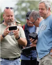  ?? Andy Lambert ?? Families at Woodford to watch the Vulcan fly over on Saturday, left, and, above, plane-spotters share pictures of the iconic bomber