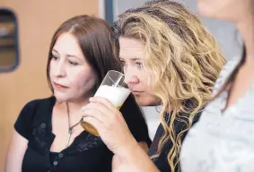  ?? ADOLPHE PIERRE-LOUIS/JOURNAL ?? Dorian Fisk, center, smells beer during a recent draught systems class at Central New Mexico Community College. Fisk was among the students who worked on CNM’s goldmedal-winning beer. At left is Laurie Chavez.