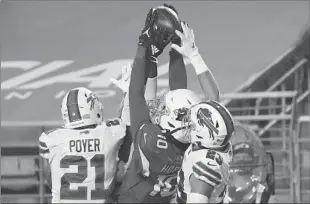  ?? CHRISTIAN PETERSEN/GETTY ?? DeAndre Hopkins hauls in the game-winning TD against the defense of safeties Jordan Poyer and Micah Hyde during the Cardinals’ victory over the Bills on Sunday. The Cardinals are tied for first in the NFCWest.