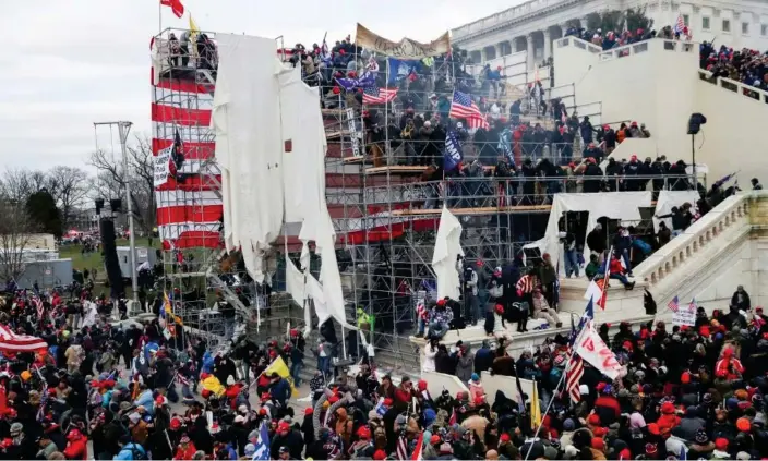  ?? ?? Trump supporters attacking the US Capitol on 6 January 2021. Photograph: Leah Millis/Reuters