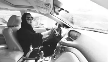  ??  ?? Saudi Activist Manal Al Sharif, who now lives in Dubai, drives her car in Gulf Emirates as she campaigns in solidaruty with Saudi women.