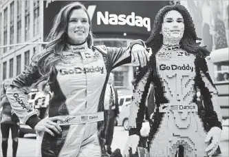  ?? BEBETO MATTHEWS
THE ASSOCIATED PRESS ?? Danica Patrick, left, poses with a life-size Lego statue creation of herself in New York on Tuesday. Lego master builder Chris Steininger says it took him 200 hours to build, using under 15,000 pieces and 13 colours.