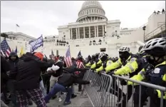  ?? AP file photo ?? Insurrecti­onists loyal to President Donald Trump try to break through a police barrier on Jan. 6, 2021, at the Capitol in Washington.