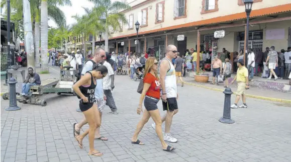  ??  ?? In this file photo, tourists are out shopping in Trelawny, Jamaica. The Americas, including the Caribbean, are home to many of the world’s most tourism-dependent economies which have been hard hit by the coronaviru­s pandemic.