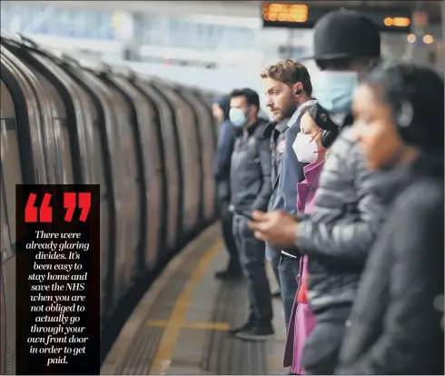  ?? PICTURE: PA. ?? INFECTION THREAT:
Passengers wear face masks and stand apart on a London Undergroun­d platform, as the lockdown is eased for workers.