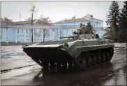  ?? YEVHEN TITOV — THE ASSOCIATED PRESS ?? A Ukrainian armoured personnel carrier rides in Chasiv Yar, the site of the heaviest battles with the Russian troops, Donetsk region, Ukraine, Monday.