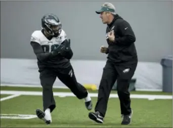  ?? MATT ROURKE — THE ASSOCIATED PRESS ?? Head coach Doug Pederson goes over a drill with rookie defensive end Derek Barnett during practice at the NovaCare Complex Friday.