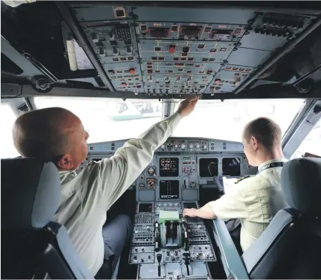  ?? Bloomberg ?? Two pilots, such as aboard this Siberian Airlines Airbus A319, are the norm – for now