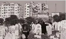  ?? AFP ?? Syrian families visit the graves of their relatives on the first day of Eid, in Idlib, on May 2