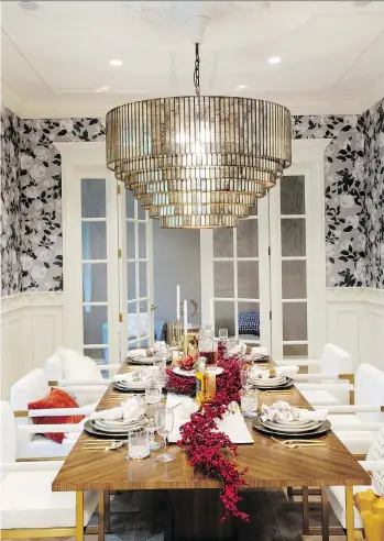  ?? PHOTOS: JANIS NICOLAY ?? A Christmas-themed dining room table was set featuring rich reds, gold and warm spice tones for the Homes for the Holidays tour by interior design firm House of Bohn.