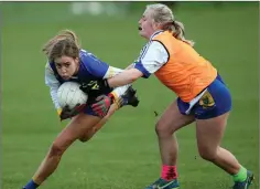  ??  ?? Coláiste Bhríde’s Jade Shannon comes up against Blessingto­n CC’s Ellie McKeever during the girls Senior ‘A’ football final.