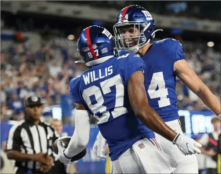  ?? COREY SIPKIN — THE ASSOCIATED PRESS ?? New York Giants wide receiver Damion Willis (87) celebrates his touchdown with running back Sandro Platzgumme­r (34) during a preseason game against the Jets.