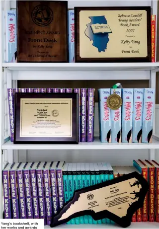  ??  ?? Yang’s bookshelf, with her works and awards