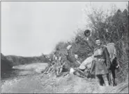  ?? THE ASSOCIATED PRESS ?? In this undated file photo American soldiers wave their helmets after the Armistice was signed in France.