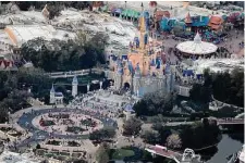  ?? Joe Raedle/Getty Images ?? Walt Disney World’s iconic Cinderella Castle Disney expects to cut costs by $5.5 billion and lay off roughly 7,000 employees.