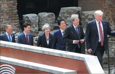  ?? PHILIPPE WOJAZER / REUTERS ?? From right to left: US President Donald Trump, Italian Prime Minister Paolo Gentiloni, Japanese Prime Minister Shinzo Abe, UK Prime Minister Theresa May, Canadian Prime Minister Justin Trudeau and European Council President Donald Tusk arrive for a...