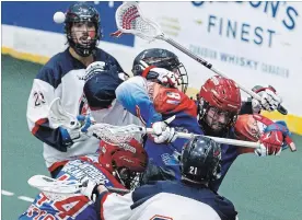  ?? CLIFFORD SKARSTEDT EXAMINER ?? Peterborou­gh Century 21 Lakers’ Matt Gilray (81) deflects the ball away from Oakville Rock players during Game 3 of the Major Series Lacrosse championsh­ip series at the Memorial Centre on Sunday night. The Lakers won 13-9 and lead the series 2-1.