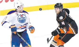  ??  ?? Oilers centre Connor McDavid and Ducks defenceman Cam Fowler battle for the puck during the first period of Game 1 in Anaheim on Wednesday.